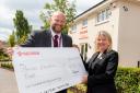 Dafydd Lawday, Chief Executive of Mercian Educational Trust, receives cheque from Donna Sabin, Sales Executive at Redrow Kensington Gate