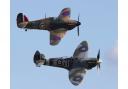 A Spitfire (front) and a Hurricane (back) fly in tandem.