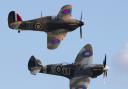 A Spitfire (front) and a Hurricane (back) fly in tandem.