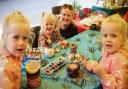 Twins Ruby and Myla aged three, their cousin Lily aged three and her mum Jade, at the Gardening for Kids pop-up session on the Market Square, Saffron Walden