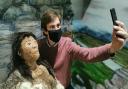 An Old Stone Age woman invites visitors to share a ‘selfie’ against an Ice Age backdrop at Saffron Walden Museum