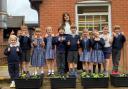 The Dame Bradbury's eco-committee with the flowers they are growing