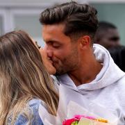 Ekin-Su Culculoglu and Davide Sanclimenti, Love Island 2022 winners, share a kiss at Stansted Airport in Essex after returning to the UK