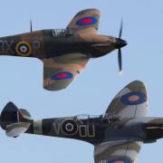 A Spitfire (front) and a Hurricane (back) fly in tandem.