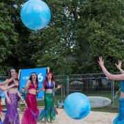 Mermaids from Pure Rhythm School of Performing Arts at the man-made beach which has opened on The Common, Saffron Walden