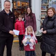 Matt Brady and Julie Redfern presenting vouchers to Vicki, Adam and Emily Cross