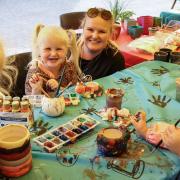 Twins Ruby and Myla aged three, their cousin Lily aged three and her mum Jade, at the Gardening for Kids pop-up session on the Market Square, Saffron Walden