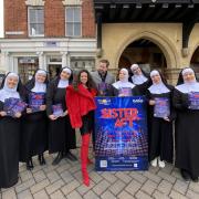 The cast of Sister Act in Saffron Walden, starring Gemma Alexander (in red) as Deloris