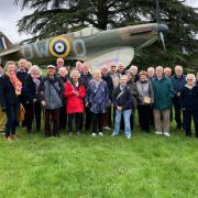 Members of the Probus Club in front of a Battle of Britain Spitfire