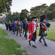 Town crier Matt Clare leads the D-Day procession