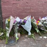 Flowers are left at the scene in Napier Road, East Ham, London (Rosie Shead/PA)