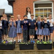 The Dame Bradbury's eco-committee with the flowers they are growing