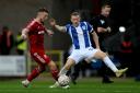 Full stretch - Arthur Read challenges for possession during Colchester United's FA Cup exit to Swindon Town