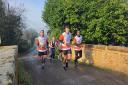 James Syree, Lucinda Ramsey, Jacob Constable and Matthew Clarke, all of Ballard LLP, in action during their 10 mile run