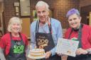 Celebration -Julie Claxton, Alan Wyatt and Fiorella Abbarchi celebrating the amount of hours they have volunteered