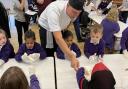 Children taking part in the apple workshop at Wimbish Primary Academy