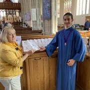 Secretary of the Friends of St Mary's Church Pamela Mugliston shows the translated guide to Ukrainian choral scholar Stas