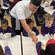 Children taking part in the apple workshop at Wimbish Primary Academy