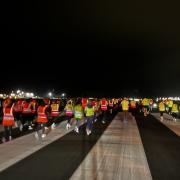 Nearly 100 airport staff ran, jogged, and walked the course